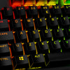 HyperX PBT Keycaps in Black closeup with RGB lighting from keyboard