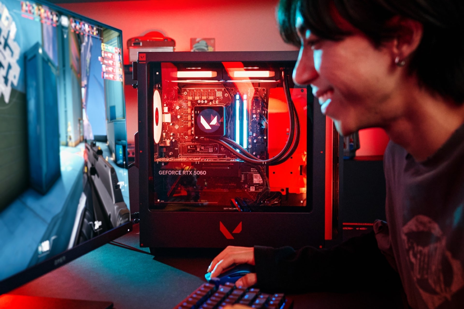 Person playing a video game on a computer with a visible OMEN gaming rig.