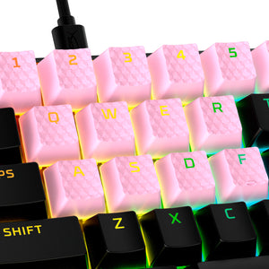 closeup view of HyperX rubber keycaps in pink with lit keyboard